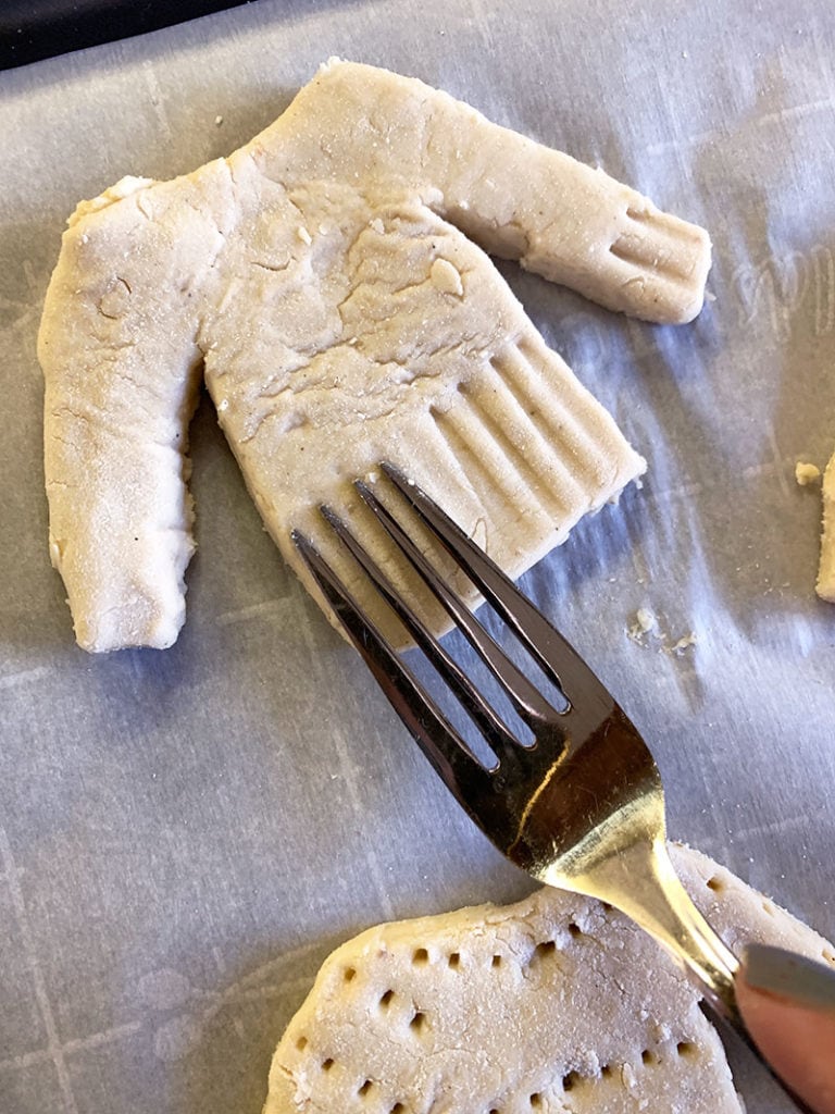 Decorate cookies by adding decorations with a fork before baking