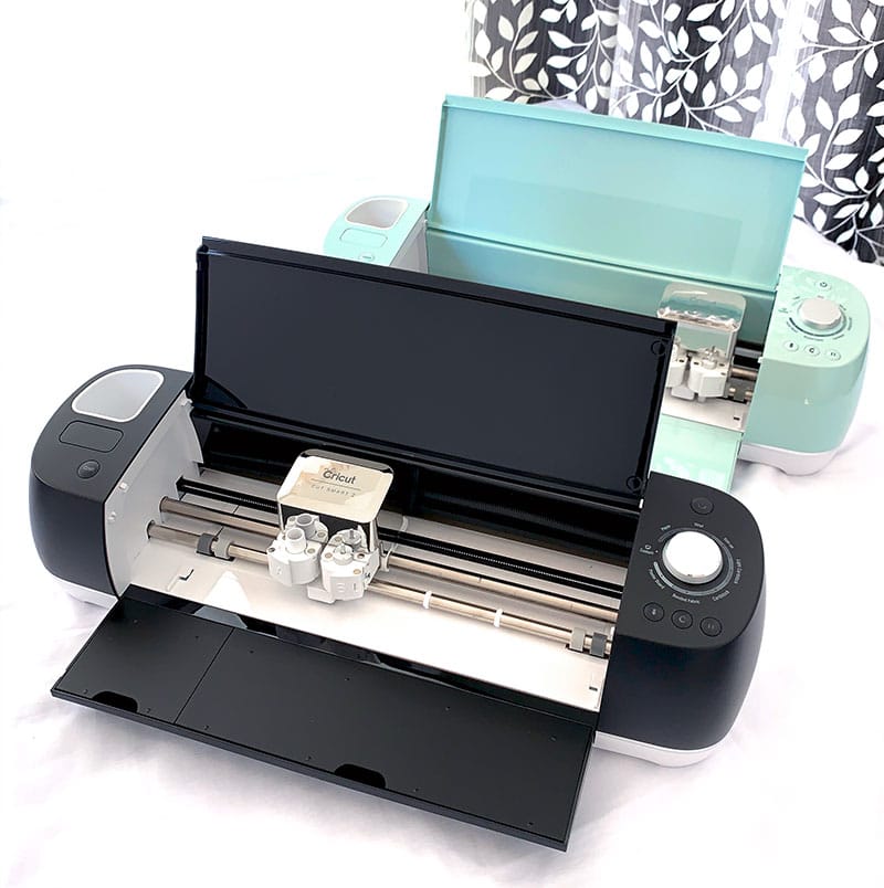 Cricut Explore Air 2 electronic cutting machines in black and light teal