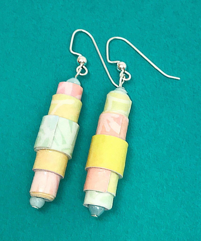 Rolled Paper bead earrings on blue background.