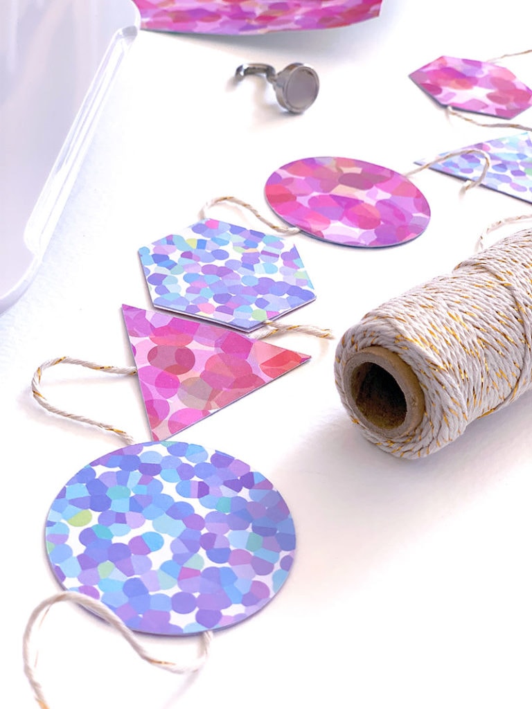 attach garland paper cutouts to twine