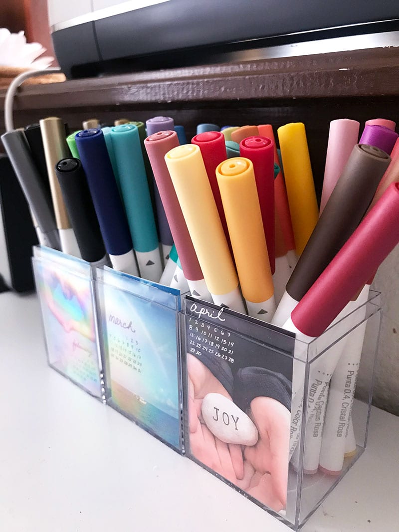 Use plastic boxes to create a clean organized look for pens pencils and markers
