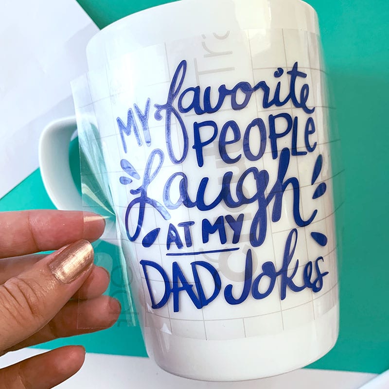Use transfer tape to customize a mug with vinyl word art