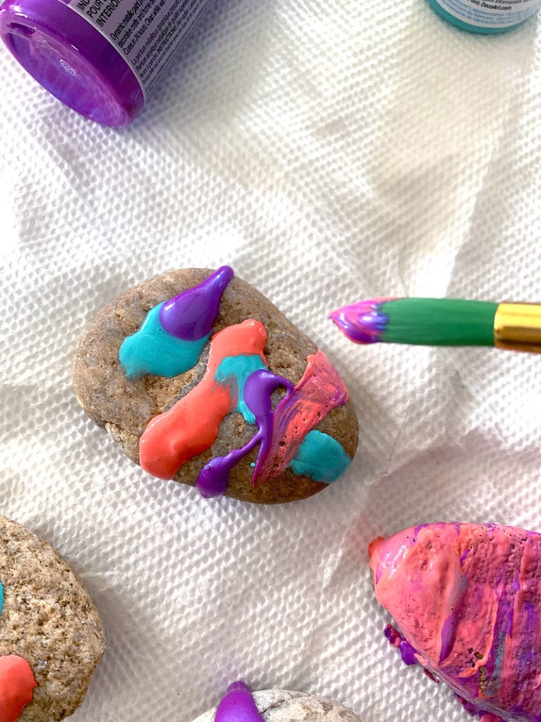 Use multiple paint colors at once to paint rock art