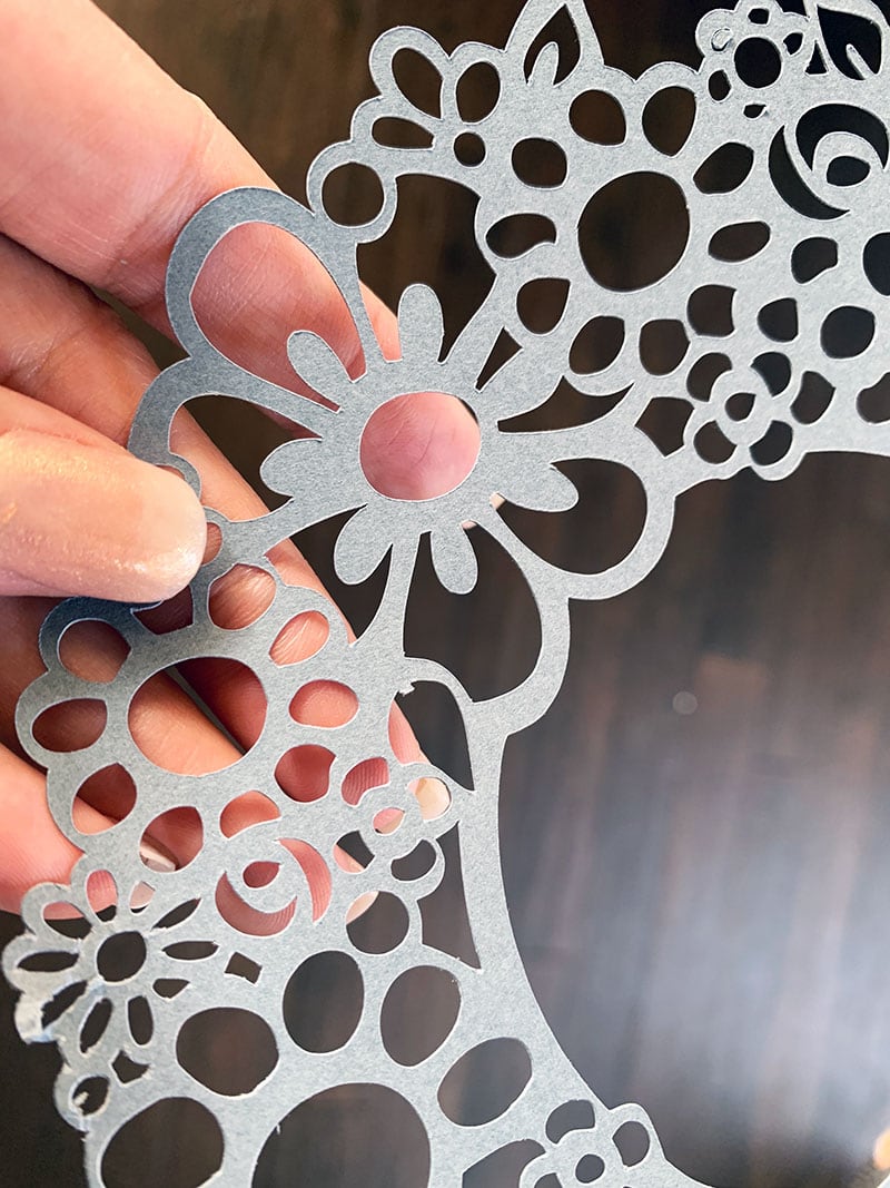 Using your Cricut, cut a fancy floral design to personal projects with monograms