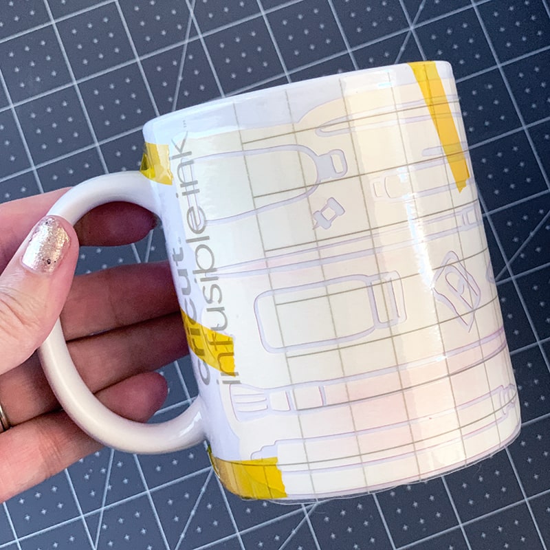 Wrap cut design around the mug and adhere in place with heat resistant tape